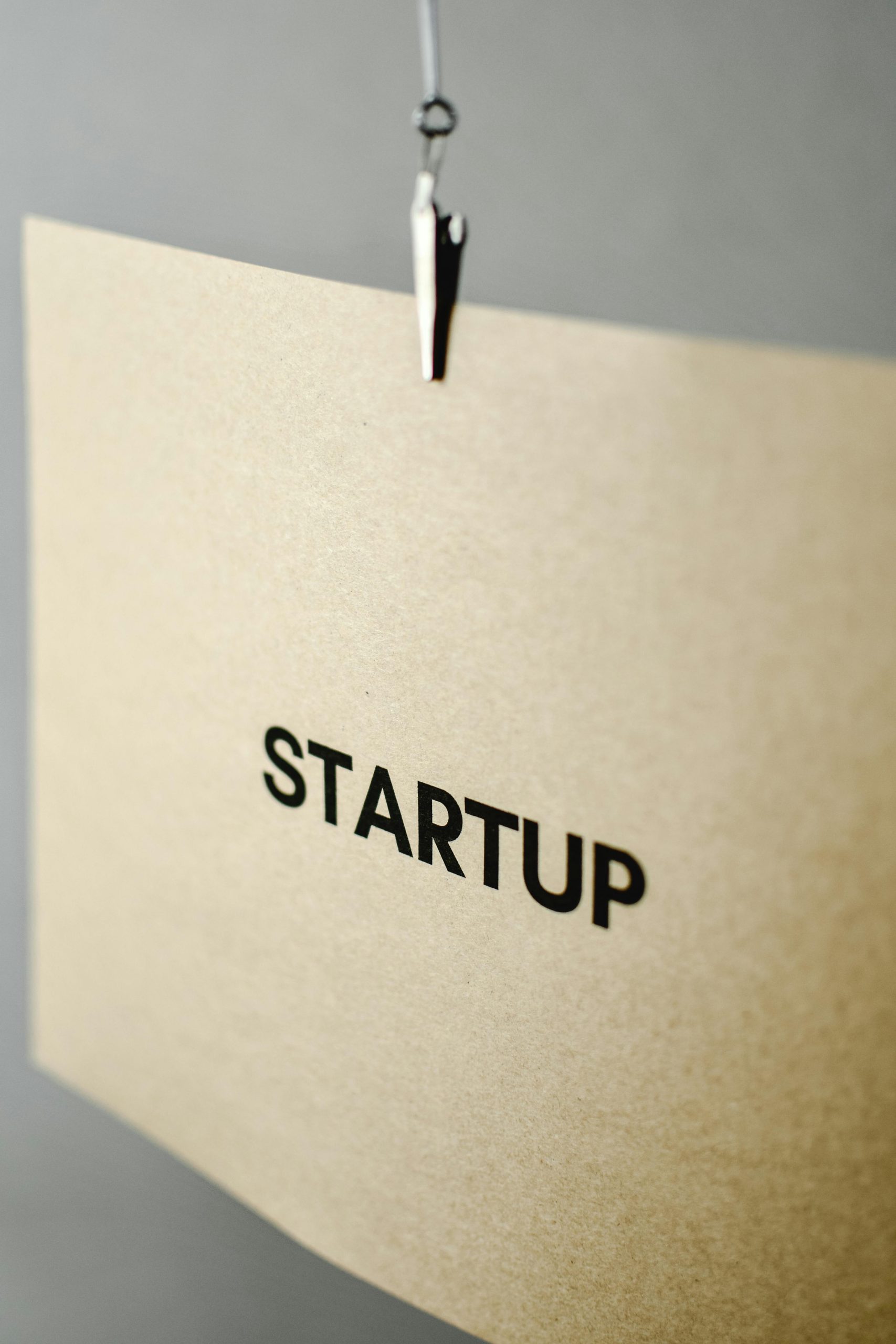 Close-up of a brown paper sign with the word 'Startup', symbolizing entrepreneurship.
